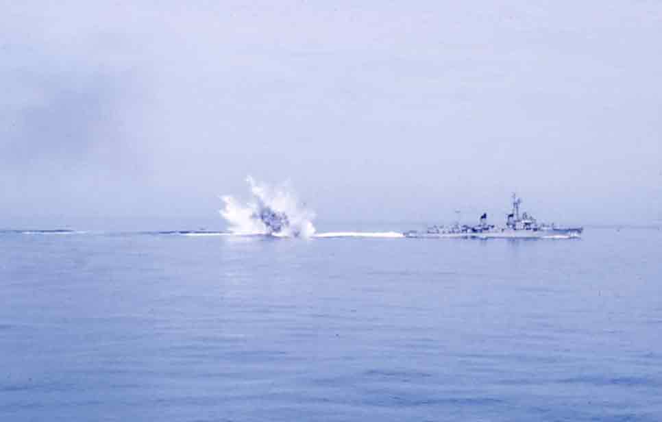 Photo - USS Rich rolls a depth charge during a demonstration